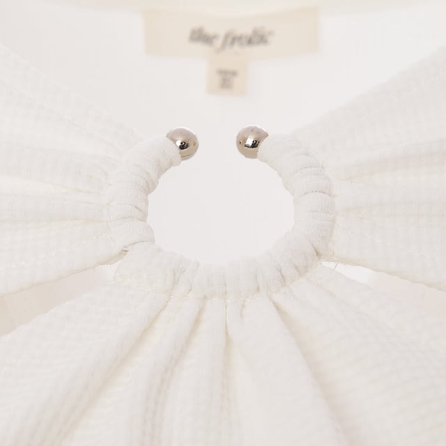 Body: 95% Polyester, Body: 5% Elastane. The Frolic cut-out detail crop top is a stunning piece that embodies modern fashion with a daring twist. Its crisp white hue complements the bold v-neck design, while the ring and cut-out details add an edgy touch. The cropped length and slim fit accentuate the silhouette, making it a perfect choice for daywear that stands out. This top is not just clothing; it's a statement piece that says you're confident, stylish, and unafraid to push boundaries.