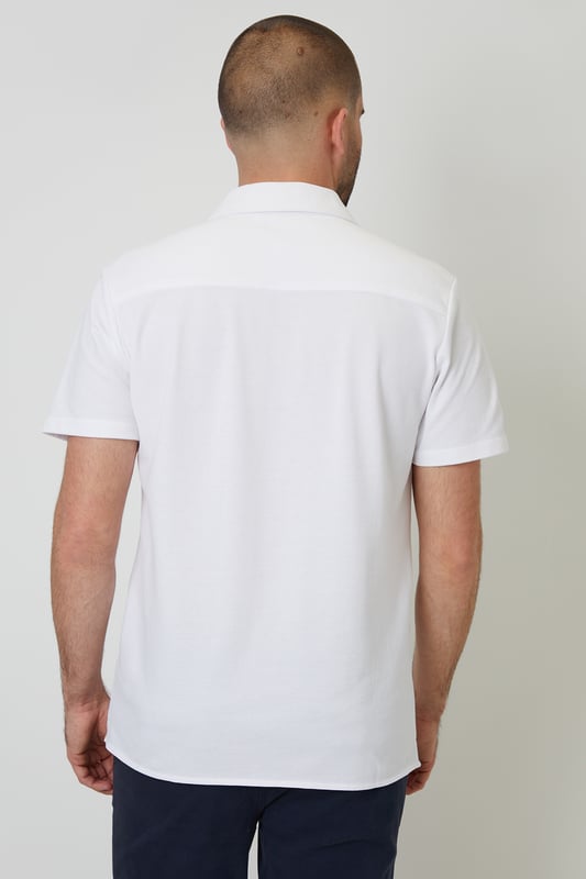 This lightweight pique shirt from Threadbare will have you ready for the summer months. Crafted with a from a soft cotton jersey pique, this shirt features a revere collar with single needle stitching and a button-through fastening. The short sleeves and side split vents offer comfort and breathability for warm days. Complete with a back yoke seam for added detail, this shirt is perfect for casual outings or beachside gatherings. Pair it with tailored shorts or lightweight trousers for a relaxed look that's ideal for sunny days and balmy evenings.