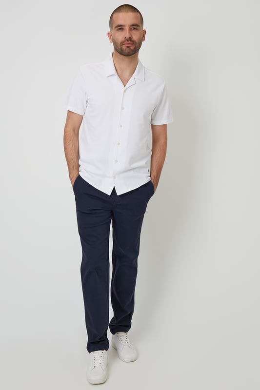 This lightweight pique shirt from Threadbare will have you ready for the summer months. Crafted with a from a soft cotton jersey pique, this shirt features a revere collar with single needle stitching and a button-through fastening. The short sleeves and side split vents offer comfort and breathability for warm days. Complete with a back yoke seam for added detail, this shirt is perfect for casual outings or beachside gatherings. Pair it with tailored shorts or lightweight trousers for a relaxed look that's ideal for sunny days and balmy evenings.