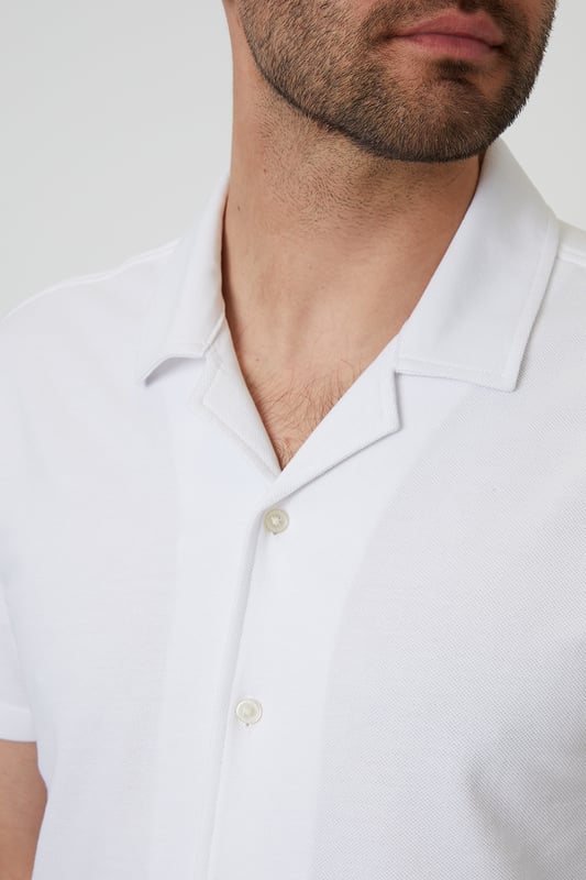 This lightweight pique shirt from Threadbare will have you ready for the summer months. Crafted with a from a soft cotton jersey pique, this shirt features a revere collar with single needle stitching and a button-through fastening. The short sleeves and side split vents offer comfort and breathability for warm days. Complete with a back yoke seam for added detail, this shirt is perfect for casual outings or beachside gatherings. Pair it with tailored shorts or lightweight trousers for a relaxed look that's ideal for sunny days and balmy evenings.