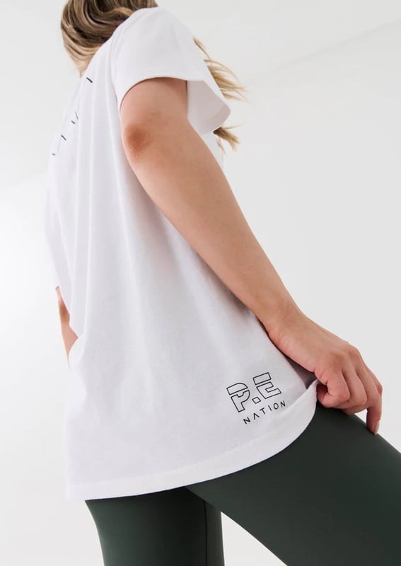 70% ORGANIC COTTON &amp; 30% HEMP. Relaxed fit, longline tee. Fine ribbed neckline. KAAIAA mantra across the front and logo at back. P.E Nation logo on hem