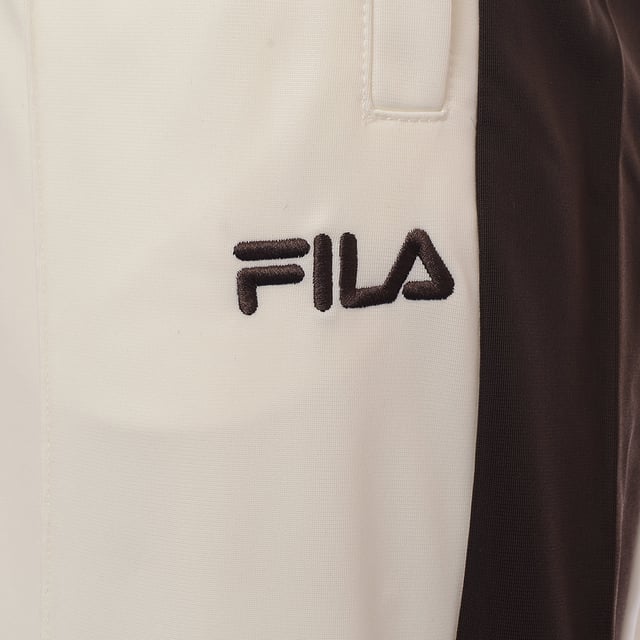 Main: 100% Polyester Imagine slipping into the comfort of Fila's unisex straight-leg joggers in a rich, earthy brown. The cuffed legs offer a snug fit, perfect for a jog or a relaxed day out. With pockets to keep your essentials secure and a subtle logo that speaks to the brand's understated style, these joggers blend functionality with a sleek design. They're not just a piece of clothing; they're a statement of comfort and style. Whether you're lounging at home or out on the town, these joggers are sure to become a go-to in your wardrobe.