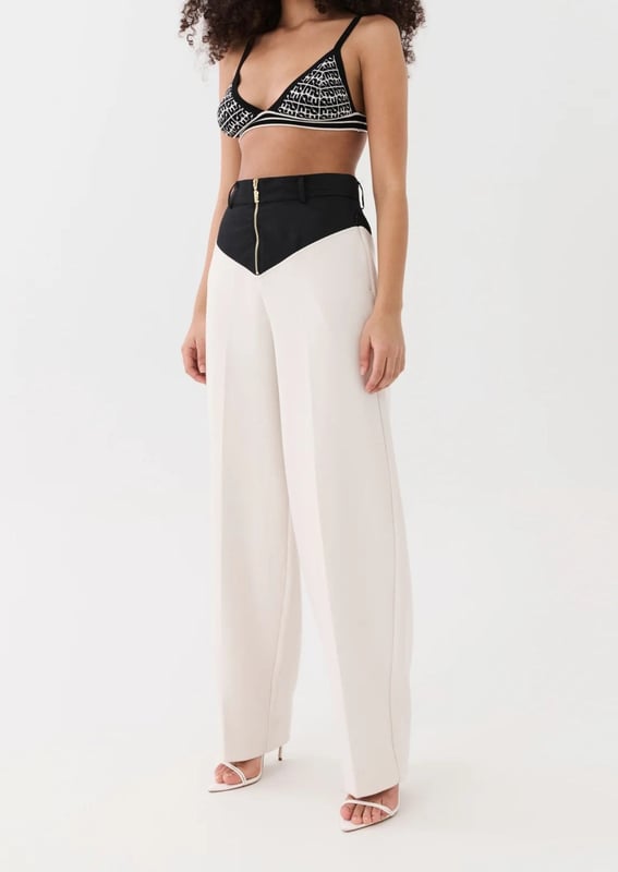 70% Polyester, 26% Rayon &amp; 4% Elastane. High waisted, relaxed straight leg style trousers. Thick crepe suiting fabrication with a contrast spray fabrication at the waist. Belt loops at wasit and side pockets with invisible zipper