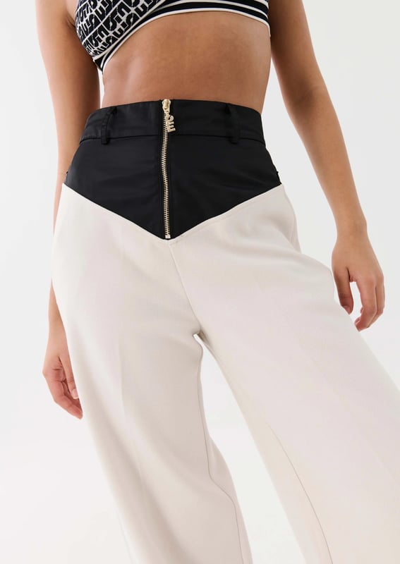 70% Polyester, 26% Rayon &amp; 4% Elastane. High waisted, relaxed straight leg style trousers. Thick crepe suiting fabrication with a contrast spray fabrication at the waist. Belt loops at wasit and side pockets with invisible zipper