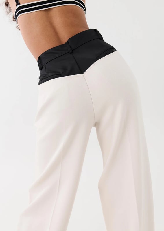 70% Polyester, 26% Rayon &amp; 4% Elastane. High waisted, relaxed straight leg style trousers. Thick crepe suiting fabrication with a contrast spray fabrication at the waist. Belt loops at wasit and side pockets with invisible zipper