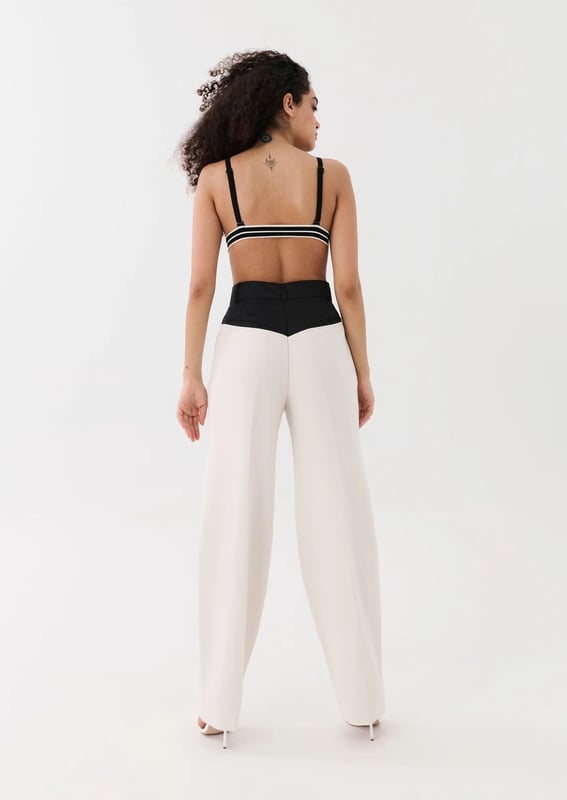 70% Polyester, 26% Rayon &amp; 4% Elastane. High waisted, relaxed straight leg style trousers. Thick crepe suiting fabrication with a contrast spray fabrication at the waist. Belt loops at wasit and side pockets with invisible zipper