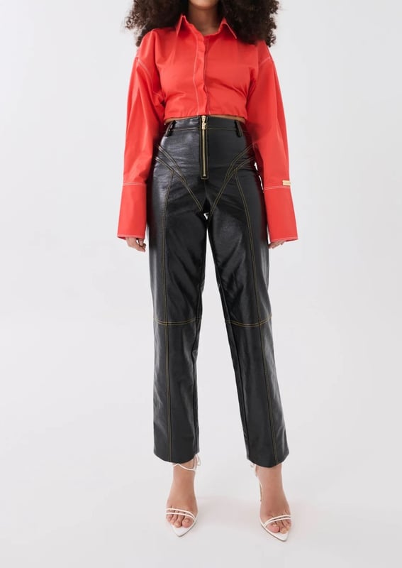100% PU. High rise, straight leg fashion trousers. Sculpted contrast muted yellow stitching. P.E Nation gold-plated centre-front zipper. Soft PU fabrication