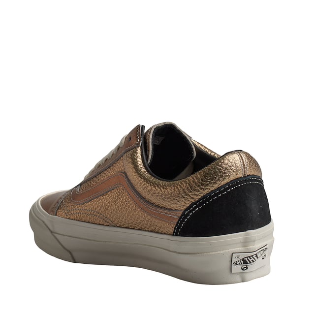 Zapatillas Vans Old Skool 36 Lx Precious Medals Bronze

Las Vans Old Skool 36 son unas zapatillas que nunca pasan de moda. Este modelo de skate existe desde los años 70 y representa el estilo de vida californiano. Su diseño sencillo y su legendaria suela vulcanizada las convierten en un clásico único en la historia de las zapatillas.

Detalles:
- Zapato icónico de caña baja con Sidestripe.
- Parte superior de piel texturizada.
- Acabado metálico.
- Entresuela vulcanizada.
- Suela de goma.
- Cordones planos que eliminan los puntos de presión en el empeine para un ajuste perfecto y mayor comodidad.

Las zapatillas Vans son mucho más que un calzado: representan una actitud, un estilo de vida urbano y rebelde. Ya sea en su clásica silueta Old Skool, en las icónicas Slip-On o en las modernas colaboraciones con artistas y marcas, Vans sigue siendo un símbolo de autenticidad, creatividad y cultura alternativa.
 Composición: Exterior: Piel; Interior: Textil; Suela: Sintético
 Cuidados:
Limpiar con un cepillo suave y jabón neutro.
Evitar lavar en máquina.
Secar al aire, lejos del sol directo.