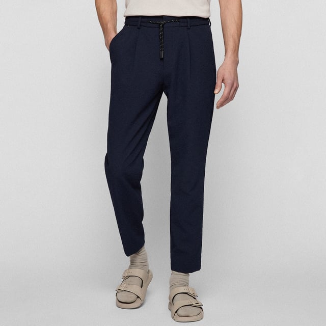 Hook eye and zip fastening.Elasticated drawstring waist.Slit side pockets.Slightly tapered cut.