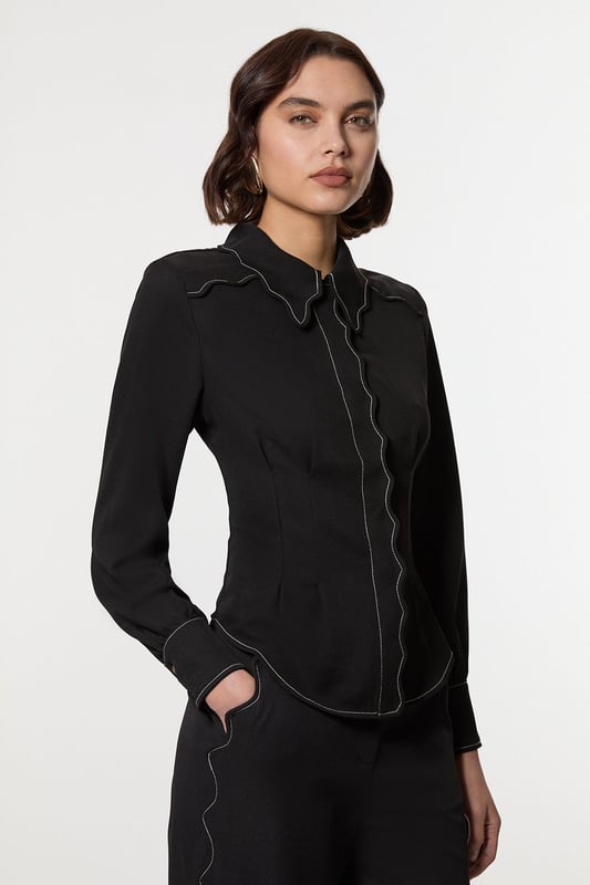 Add a little formality in our blouse. The scalloped design gives a playful yet elevated feel, and the relaxed silhouette makes for a comfortable blouse that can be worn from day to night. This piece pairs well with anything, from a flowing maxi skirt, to tailored trousers, to jeans for an elevated daytime look. Scallop Trim Woven Crepe Blouse High Quality Crepe Fabric Textured, Scalloped Details High, Collared Neckline Relaxed Fit Contrast Stitch Detailing