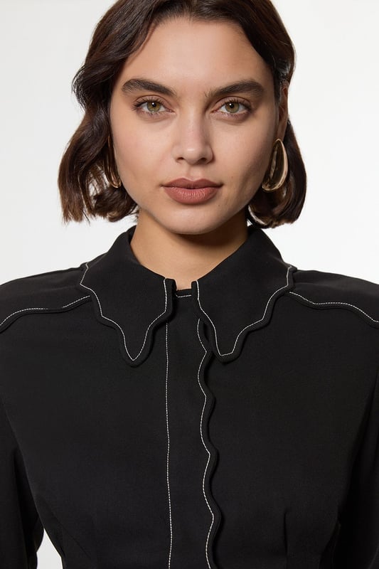 Add a little formality in our blouse. The scalloped design gives a playful yet elevated feel, and the relaxed silhouette makes for a comfortable blouse that can be worn from day to night. This piece pairs well with anything, from a flowing maxi skirt, to tailored trousers, to jeans for an elevated daytime look. Scallop Trim Woven Crepe Blouse High Quality Crepe Fabric Textured, Scalloped Details High, Collared Neckline Relaxed Fit Contrast Stitch Detailing