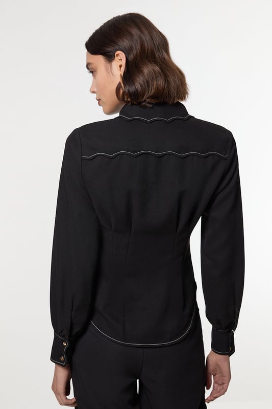 Add a little formality in our blouse. The scalloped design gives a playful yet elevated feel, and the relaxed silhouette makes for a comfortable blouse that can be worn from day to night. This piece pairs well with anything, from a flowing maxi skirt, to tailored trousers, to jeans for an elevated daytime look. Scallop Trim Woven Crepe Blouse High Quality Crepe Fabric Textured, Scalloped Details High, Collared Neckline Relaxed Fit Contrast Stitch Detailing