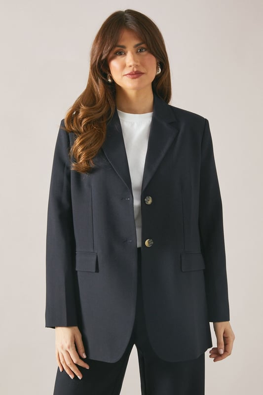 Classic single-breasted design with two-button closure
        Notched lapel for a timeless, sophisticated look
        Long sleeves with button cuffs for a polished finish
        Regular fit offering comfort and ease of movement
        Versatile woven fabric suitable for various occasions
    
    Embrace effortless sophistication with this Wallis single-breasted blazer. Perfect for the woman who appreciates both style and comfort, this versatile piece seamlessly transitions from day to evening wear. The regular fit ensures a flattering silhouette while allowing for easy layering over your favourite tops. Style it with tailored trousers and a crisp white shirt for a smart daytime look, or pair it with a silk camisole and wide-leg trousers for a more relaxed ensemble. For casual outings, throw it over a simple t-shirt and pair with your go-to jeans and trainers. The blazer's adaptability makes it an ideal choice for family gatherings, lunch dates, or casual work environments. Its timeless design ensures it will remain a staple in your wardrobe for seasons to come, offering endless styling possibilities for the modern, sophisticated woman.