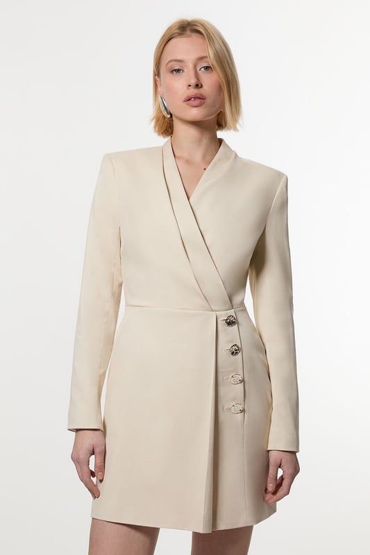 Make a statement with our striking occasion dress, which features a layered design and button detailing. Style it simply with heeled boots or statement heels for a look that will take you from wedding guest days to party season events. Soft Structured Tailored Wrap Blazer Dress Flattering Fitted Silhouette V Neckline Layered Design Unique Wrap Style Button Detailing