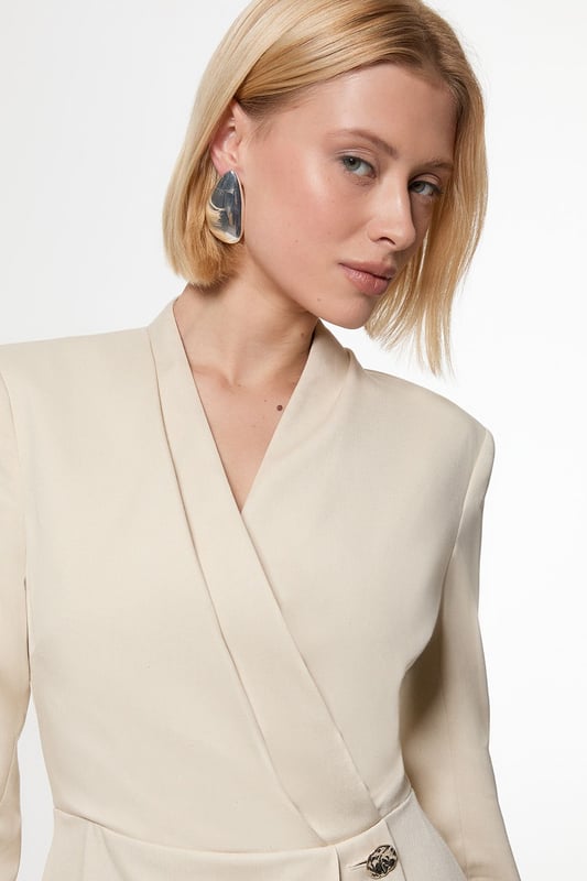 Make a statement with our striking occasion dress, which features a layered design and button detailing. Style it simply with heeled boots or statement heels for a look that will take you from wedding guest days to party season events. Soft Structured Tailored Wrap Blazer Dress Flattering Fitted Silhouette V Neckline Layered Design Unique Wrap Style Button Detailing