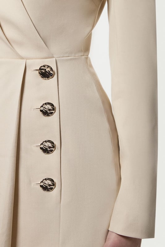 Make a statement with our striking occasion dress, which features a layered design and button detailing. Style it simply with heeled boots or statement heels for a look that will take you from wedding guest days to party season events. Soft Structured Tailored Wrap Blazer Dress Flattering Fitted Silhouette V Neckline Layered Design Unique Wrap Style Button Detailing