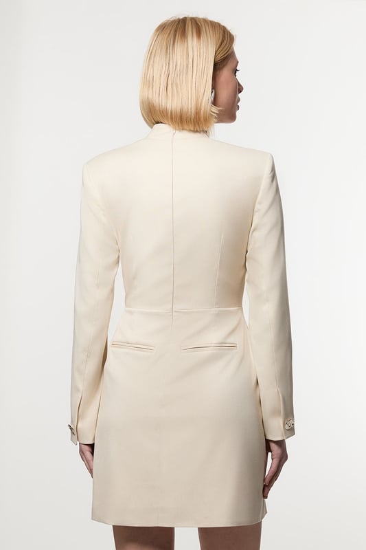 Make a statement with our striking occasion dress, which features a layered design and button detailing. Style it simply with heeled boots or statement heels for a look that will take you from wedding guest days to party season events. Soft Structured Tailored Wrap Blazer Dress Flattering Fitted Silhouette V Neckline Layered Design Unique Wrap Style Button Detailing