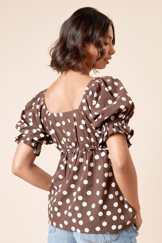 Charming square neckline with delicate gathering detail for a feminine touch
        Playful puff sleeves with elasticated cuffs for a flattering silhouette
        Lightweight cotton poplin fabric ensures breathable comfort throughout the day
        Gathered waist creates a defined shape that complements your figure
        Versatile length perfect for both tucking in or wearing loose over trousers or skirts
    
    This delightful spotted blouse from Dorothy Perkins brings a touch of whimsy to your everyday wardrobe. The square neckline frames your dcolletage beautifully, whilst the gathered detailing adds texture and dimension. Style with your favourite denim jeans and white trainers for casual weekend brunches with the girls, or dress it up with tailored trousers and ballet flats for family gatherings. The cotton fabric ensures you'll stay comfortable all day, whether you're running errands or attending a baby shower. For cooler days, layer under a cardigan or denim jacket without losing any of the blouse's charm. This versatile piece transitions effortlessly from daytime casual to evening meals - simply swap your footwear and add some statement earrings to refresh your look.