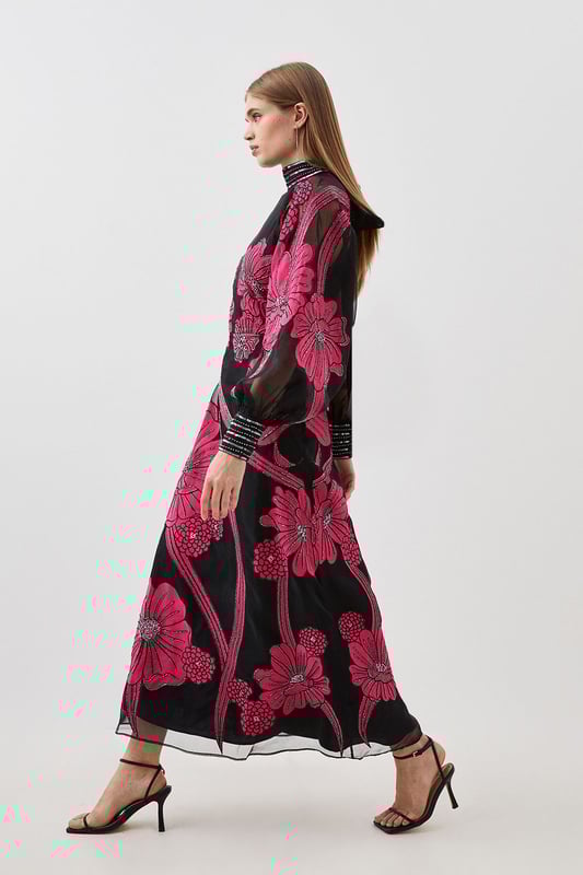 Feel formal in our maxi dress, made with high quality organdie fabric, featuring a fit and flare silhouette that flatters the curves, as well as floral applique accents. Style it with court heels or heeled boots for a look that will take you from party nights and wedding guest days. Applique Organdie Floral Graphic Maxi Dress High Quality Organdie Fabric Comfortable Fit and Flare Silhouette Long Balloon Sleeves Formal, High Neckline Flowing, Sheer Overlay Large, Floral Design Keyhole Back Accent Large Bow Feature Zip Back FasteningBrowse this seasons mother of the bride dresses or shop the full collection of women's wedding outfits now.