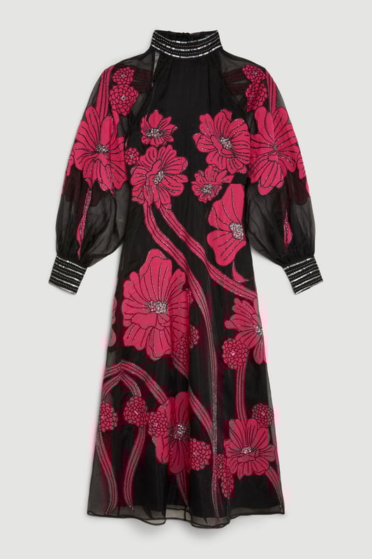 Feel formal in our maxi dress, made with high quality organdie fabric, featuring a fit and flare silhouette that flatters the curves, as well as floral applique accents. Style it with court heels or heeled boots for a look that will take you from party nights and wedding guest days. Applique Organdie Floral Graphic Maxi Dress High Quality Organdie Fabric Comfortable Fit and Flare Silhouette Long Balloon Sleeves Formal, High Neckline Flowing, Sheer Overlay Large, Floral Design Keyhole Back Accent Large Bow Feature Zip Back FasteningBrowse this seasons mother of the bride dresses or shop the full collection of women's wedding outfits now.