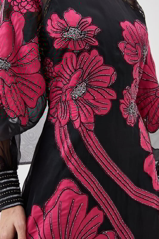 Feel formal in our maxi dress, made with high quality organdie fabric, featuring a fit and flare silhouette that flatters the curves, as well as floral applique accents. Style it with court heels or heeled boots for a look that will take you from party nights and wedding guest days. Applique Organdie Floral Graphic Maxi Dress High Quality Organdie Fabric Comfortable Fit and Flare Silhouette Long Balloon Sleeves Formal, High Neckline Flowing, Sheer Overlay Large, Floral Design Keyhole Back Accent Large Bow Feature Zip Back FasteningBrowse this seasons mother of the bride dresses or shop the full collection of women's wedding outfits now.