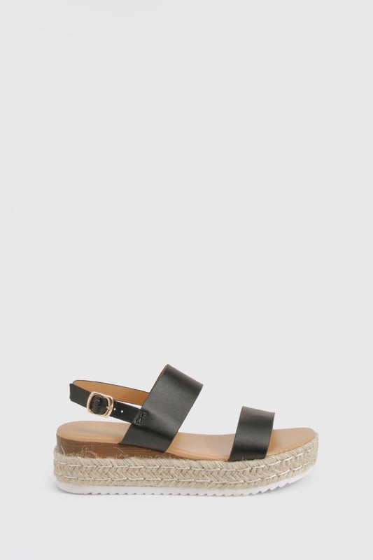 Chic double strap design for a contemporary twist on classic espadrilles
        Comfortable low heel height of 2.5-4.5cm perfect for all-day wear
        Adjustable ankle strap with buckle fastening for a secure fit
        Textured rope midsole adding authentic espadrille character
        Durable white sole providing additional grip and stability
    
    These double strap espadrilles from Boohoo blend comfort with effortless style for your summer wardrobe. The platform design creates a subtle lift while maintaining walkability, making them ideal for city breaks or beachside strolls. Style them with a flowing midi dress and oversized straw bag for daytime outings, or pair with cropped trousers and a relaxed blouse for casual family gatherings. The versatile silhouette works beautifully with both shorts and maxi skirts, offering endless styling possibilities throughout the warmer months. Their understated design ensures they'll complement both bold prints and minimalist outfits alike, while the secure ankle strap provides stability for those longer days on your feet. A true seasonal essential that combines practicality with Boohoo's signature contemporary flair.