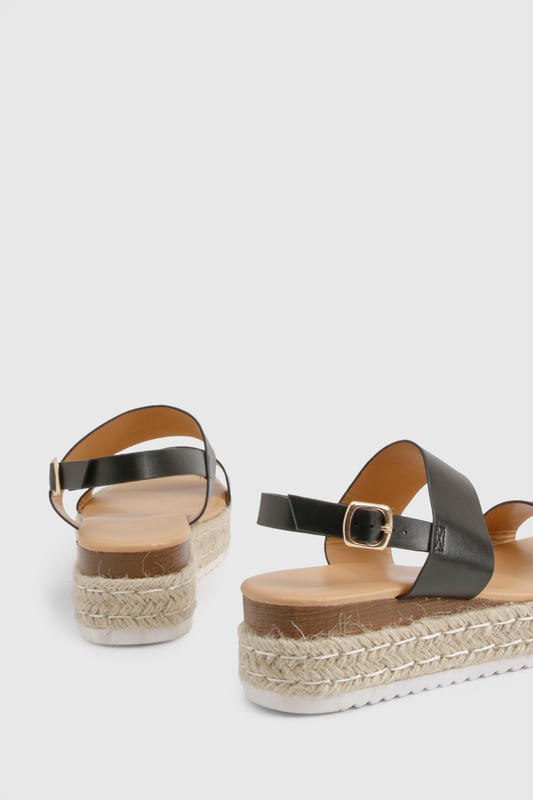 Chic double strap design for a contemporary twist on classic espadrilles
        Comfortable low heel height of 2.5-4.5cm perfect for all-day wear
        Adjustable ankle strap with buckle fastening for a secure fit
        Textured rope midsole adding authentic espadrille character
        Durable white sole providing additional grip and stability
    
    These double strap espadrilles from Boohoo blend comfort with effortless style for your summer wardrobe. The platform design creates a subtle lift while maintaining walkability, making them ideal for city breaks or beachside strolls. Style them with a flowing midi dress and oversized straw bag for daytime outings, or pair with cropped trousers and a relaxed blouse for casual family gatherings. The versatile silhouette works beautifully with both shorts and maxi skirts, offering endless styling possibilities throughout the warmer months. Their understated design ensures they'll complement both bold prints and minimalist outfits alike, while the secure ankle strap provides stability for those longer days on your feet. A true seasonal essential that combines practicality with Boohoo's signature contemporary flair.