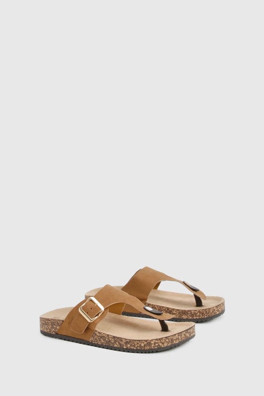 Trendy toe-post design for a classic summer look
        Adjustable buckle strap for a customised fit
        Comfortable cork-effect footbed for all-day wear
        Flat heel between 0 and 2cm for easy walking
        Versatile style suitable for various casual occasions
    
    Step into summer with these effortlessly chic slides from Boohoo. Perfect for the fashion-forward woman who values both style and comfort, these sandals are a must-have for your warm-weather wardrobe. The toe-post design adds a touch of classic appeal, while the adjustable buckle strap ensures a snug, personalised fit. Pair them with a flowing maxi dress and oversized sunglasses for a leisurely brunch date, or slip them on with denim shorts and a crop top for a casual day out shopping. The cork-effect footbed not only adds visual interest but also provides comfort for extended wear. Whether you're heading to a family barbecue or a casual catch-up with friends, these versatile slides will keep you looking stylish and feeling comfortable all day long.