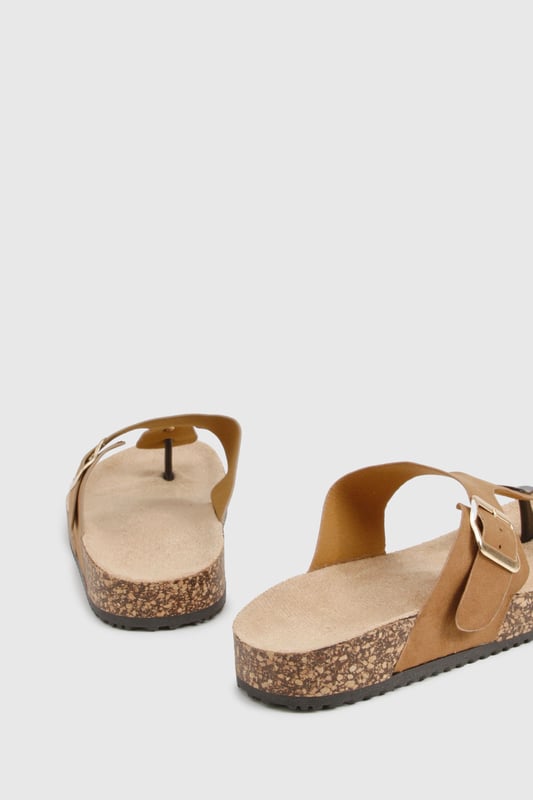 Trendy toe-post design for a classic summer look
        Adjustable buckle strap for a customised fit
        Comfortable cork-effect footbed for all-day wear
        Flat heel between 0 and 2cm for easy walking
        Versatile style suitable for various casual occasions
    
    Step into summer with these effortlessly chic slides from Boohoo. Perfect for the fashion-forward woman who values both style and comfort, these sandals are a must-have for your warm-weather wardrobe. The toe-post design adds a touch of classic appeal, while the adjustable buckle strap ensures a snug, personalised fit. Pair them with a flowing maxi dress and oversized sunglasses for a leisurely brunch date, or slip them on with denim shorts and a crop top for a casual day out shopping. The cork-effect footbed not only adds visual interest but also provides comfort for extended wear. Whether you're heading to a family barbecue or a casual catch-up with friends, these versatile slides will keep you looking stylish and feeling comfortable all day long.