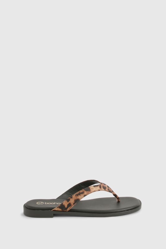 Chunky strap flip-flops featuring an eye-catching animal print design
        Satin finish straps for a touch of luxe texture
        Flat heel measuring between 0-2cm for all-day comfort
        Durable sole with subtle branding detail
        Regular fit toe post design for easy wear
    
    These statement flip-flops combine practicality with on-trend style, perfect for the fashion-forward woman who values both comfort and flair. The chunky straps with their striking animal print pattern add a bold touch to even the simplest outfit, whilst the satin finish introduces a subtle sheen that catches the light beautifully. Pair with cropped jeans and an oversized tee for casual coffee dates, or style with a floaty maxi dress for laid-back summer gatherings. The flat design ensures these sandals remain comfortable throughout long days of wear, making them an ideal choice for holiday sightseeing or festival adventures. Their versatility means they'll transition effortlessly from beachside to city streets, offering a stylish footwear solution for the British summer and beyond. A true wardrobe essential that brings a touch of wild charm to your everyday look.