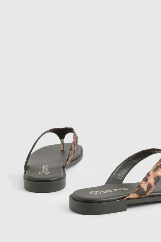 Chunky strap flip-flops featuring an eye-catching animal print design
        Satin finish straps for a touch of luxe texture
        Flat heel measuring between 0-2cm for all-day comfort
        Durable sole with subtle branding detail
        Regular fit toe post design for easy wear
    
    These statement flip-flops combine practicality with on-trend style, perfect for the fashion-forward woman who values both comfort and flair. The chunky straps with their striking animal print pattern add a bold touch to even the simplest outfit, whilst the satin finish introduces a subtle sheen that catches the light beautifully. Pair with cropped jeans and an oversized tee for casual coffee dates, or style with a floaty maxi dress for laid-back summer gatherings. The flat design ensures these sandals remain comfortable throughout long days of wear, making them an ideal choice for holiday sightseeing or festival adventures. Their versatility means they'll transition effortlessly from beachside to city streets, offering a stylish footwear solution for the British summer and beyond. A true wardrobe essential that brings a touch of wild charm to your everyday look.