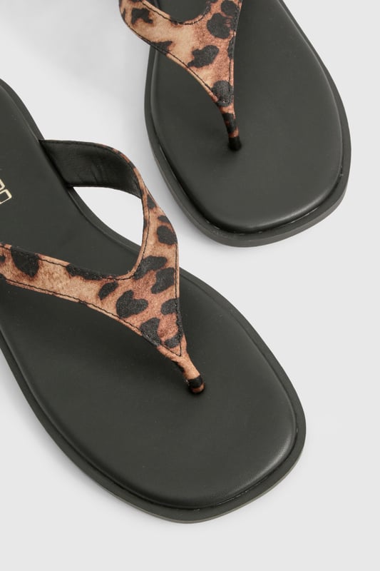 Chunky strap flip-flops featuring an eye-catching animal print design
        Satin finish straps for a touch of luxe texture
        Flat heel measuring between 0-2cm for all-day comfort
        Durable sole with subtle branding detail
        Regular fit toe post design for easy wear
    
    These statement flip-flops combine practicality with on-trend style, perfect for the fashion-forward woman who values both comfort and flair. The chunky straps with their striking animal print pattern add a bold touch to even the simplest outfit, whilst the satin finish introduces a subtle sheen that catches the light beautifully. Pair with cropped jeans and an oversized tee for casual coffee dates, or style with a floaty maxi dress for laid-back summer gatherings. The flat design ensures these sandals remain comfortable throughout long days of wear, making them an ideal choice for holiday sightseeing or festival adventures. Their versatility means they'll transition effortlessly from beachside to city streets, offering a stylish footwear solution for the British summer and beyond. A true wardrobe essential that brings a touch of wild charm to your everyday look.