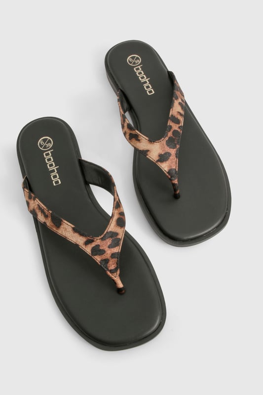 Chunky strap flip-flops featuring an eye-catching animal print design
        Satin finish straps for a touch of luxe texture
        Flat heel measuring between 0-2cm for all-day comfort
        Durable sole with subtle branding detail
        Regular fit toe post design for easy wear
    
    These statement flip-flops combine practicality with on-trend style, perfect for the fashion-forward woman who values both comfort and flair. The chunky straps with their striking animal print pattern add a bold touch to even the simplest outfit, whilst the satin finish introduces a subtle sheen that catches the light beautifully. Pair with cropped jeans and an oversized tee for casual coffee dates, or style with a floaty maxi dress for laid-back summer gatherings. The flat design ensures these sandals remain comfortable throughout long days of wear, making them an ideal choice for holiday sightseeing or festival adventures. Their versatility means they'll transition effortlessly from beachside to city streets, offering a stylish footwear solution for the British summer and beyond. A true wardrobe essential that brings a touch of wild charm to your everyday look.
