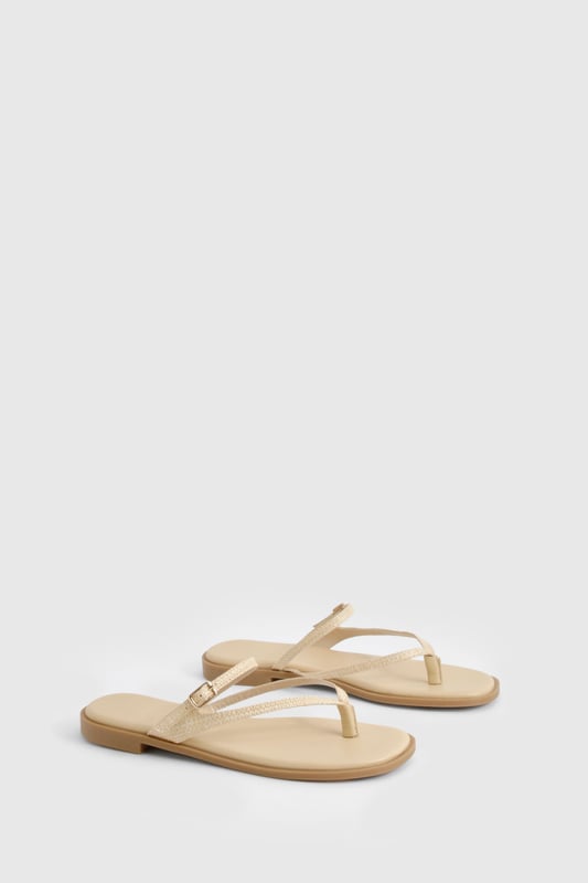 Crafted from natural raffia material for a textured summer look
        Elegant double strap design with delicate toe post detail
        Adjustable buckle fastening for a customised fit
        Flat heel measuring between 0-2cm for all-day comfort
        Versatile neutral tone that complements any summer ensemble
    
    These double-strap sandals offer the perfect blend of style and practicality for your warm-weather wardrobe. The minimalist design features delicate straps that gracefully cross the foot, creating a flattering silhouette that works brilliantly with both casual and semi-formal outfits. Pair with floaty midi dresses and straw accessories for daytime beach strolls, or style with cropped linen trousers and a crisp blouse for family gatherings. The flat sole ensures comfort for extended wear, making these sandals ideal for city sightseeing or garden parties. Their understated elegance allows for effortless transitioning from day to evening - simply add some statement jewellery to transform your look. The adjustable strap ensures these sandals stay securely in place whilst you're on the move, making them a reliable choice for your summer adventures.