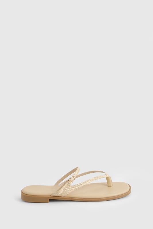 Crafted from natural raffia material for a textured summer look
        Elegant double strap design with delicate toe post detail
        Adjustable buckle fastening for a customised fit
        Flat heel measuring between 0-2cm for all-day comfort
        Versatile neutral tone that complements any summer ensemble
    
    These double-strap sandals offer the perfect blend of style and practicality for your warm-weather wardrobe. The minimalist design features delicate straps that gracefully cross the foot, creating a flattering silhouette that works brilliantly with both casual and semi-formal outfits. Pair with floaty midi dresses and straw accessories for daytime beach strolls, or style with cropped linen trousers and a crisp blouse for family gatherings. The flat sole ensures comfort for extended wear, making these sandals ideal for city sightseeing or garden parties. Their understated elegance allows for effortless transitioning from day to evening - simply add some statement jewellery to transform your look. The adjustable strap ensures these sandals stay securely in place whilst you're on the move, making them a reliable choice for your summer adventures.