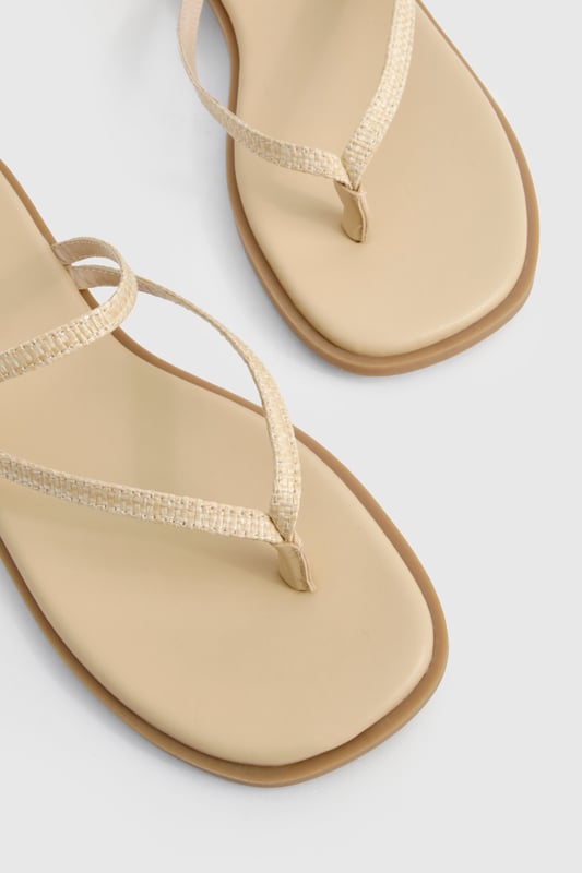 Crafted from natural raffia material for a textured summer look
        Elegant double strap design with delicate toe post detail
        Adjustable buckle fastening for a customised fit
        Flat heel measuring between 0-2cm for all-day comfort
        Versatile neutral tone that complements any summer ensemble
    
    These double-strap sandals offer the perfect blend of style and practicality for your warm-weather wardrobe. The minimalist design features delicate straps that gracefully cross the foot, creating a flattering silhouette that works brilliantly with both casual and semi-formal outfits. Pair with floaty midi dresses and straw accessories for daytime beach strolls, or style with cropped linen trousers and a crisp blouse for family gatherings. The flat sole ensures comfort for extended wear, making these sandals ideal for city sightseeing or garden parties. Their understated elegance allows for effortless transitioning from day to evening - simply add some statement jewellery to transform your look. The adjustable strap ensures these sandals stay securely in place whilst you're on the move, making them a reliable choice for your summer adventures.