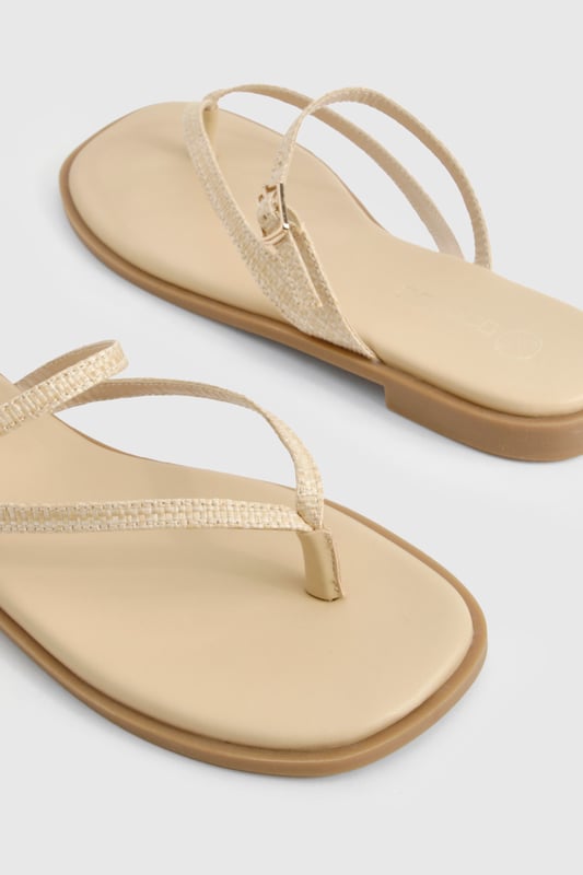 Crafted from natural raffia material for a textured summer look
        Elegant double strap design with delicate toe post detail
        Adjustable buckle fastening for a customised fit
        Flat heel measuring between 0-2cm for all-day comfort
        Versatile neutral tone that complements any summer ensemble
    
    These double-strap sandals offer the perfect blend of style and practicality for your warm-weather wardrobe. The minimalist design features delicate straps that gracefully cross the foot, creating a flattering silhouette that works brilliantly with both casual and semi-formal outfits. Pair with floaty midi dresses and straw accessories for daytime beach strolls, or style with cropped linen trousers and a crisp blouse for family gatherings. The flat sole ensures comfort for extended wear, making these sandals ideal for city sightseeing or garden parties. Their understated elegance allows for effortless transitioning from day to evening - simply add some statement jewellery to transform your look. The adjustable strap ensures these sandals stay securely in place whilst you're on the move, making them a reliable choice for your summer adventures.