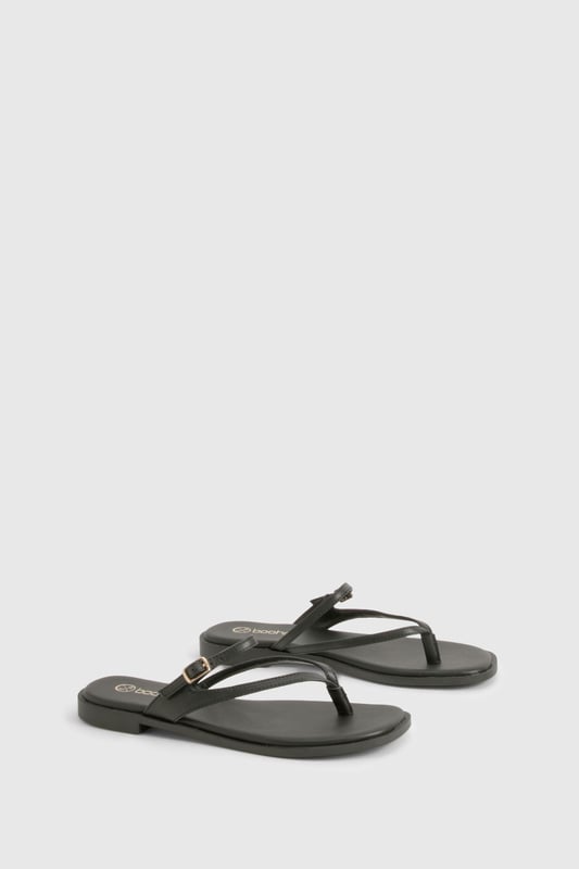 Sleek double strap design with elegant toe post detail
        Flat heel measuring between 0-2cm for all-day comfort
        Delicate gold-tone buckle fastening for adjustable fit
        Smooth PU construction with cushioned footbed
        Versatile slip-on style perfect for effortless summer dressing
    
    These minimalist double strap sandals are the ultimate warm-weather essential for the fashion-forward woman. The understated design features slender straps that delicately cross the foot, creating a flattering silhouette that works brilliantly with everything from floaty summer dresses to casual denim shorts. The practical flat sole ensures comfort for city exploring or beachside strolls, while the subtle gold-tone hardware adds just the right touch of sophistication. Style them with cropped trousers and an oversized linen shirt for daytime casual events, or pair with a flowing maxi dress for family gatherings and garden parties. These versatile sandals transition seamlessly from poolside to pavement, making them an indispensable addition to your holiday packing list and everyday summer wardrobe.