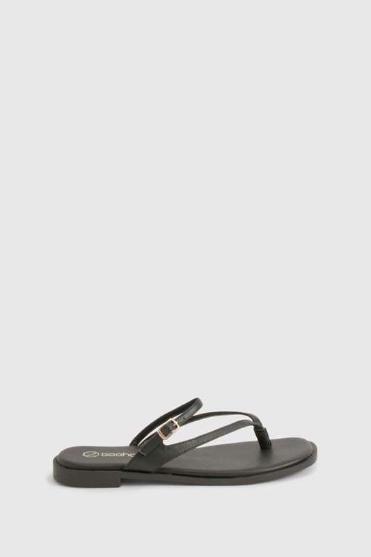 Sleek double strap design with elegant toe post detail
        Flat heel measuring between 0-2cm for all-day comfort
        Delicate gold-tone buckle fastening for adjustable fit
        Smooth PU construction with cushioned footbed
        Versatile slip-on style perfect for effortless summer dressing
    
    These minimalist double strap sandals are the ultimate warm-weather essential for the fashion-forward woman. The understated design features slender straps that delicately cross the foot, creating a flattering silhouette that works brilliantly with everything from floaty summer dresses to casual denim shorts. The practical flat sole ensures comfort for city exploring or beachside strolls, while the subtle gold-tone hardware adds just the right touch of sophistication. Style them with cropped trousers and an oversized linen shirt for daytime casual events, or pair with a flowing maxi dress for family gatherings and garden parties. These versatile sandals transition seamlessly from poolside to pavement, making them an indispensable addition to your holiday packing list and everyday summer wardrobe.