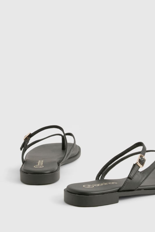 Sleek double strap design with elegant toe post detail
        Flat heel measuring between 0-2cm for all-day comfort
        Delicate gold-tone buckle fastening for adjustable fit
        Smooth PU construction with cushioned footbed
        Versatile slip-on style perfect for effortless summer dressing
    
    These minimalist double strap sandals are the ultimate warm-weather essential for the fashion-forward woman. The understated design features slender straps that delicately cross the foot, creating a flattering silhouette that works brilliantly with everything from floaty summer dresses to casual denim shorts. The practical flat sole ensures comfort for city exploring or beachside strolls, while the subtle gold-tone hardware adds just the right touch of sophistication. Style them with cropped trousers and an oversized linen shirt for daytime casual events, or pair with a flowing maxi dress for family gatherings and garden parties. These versatile sandals transition seamlessly from poolside to pavement, making them an indispensable addition to your holiday packing list and everyday summer wardrobe.