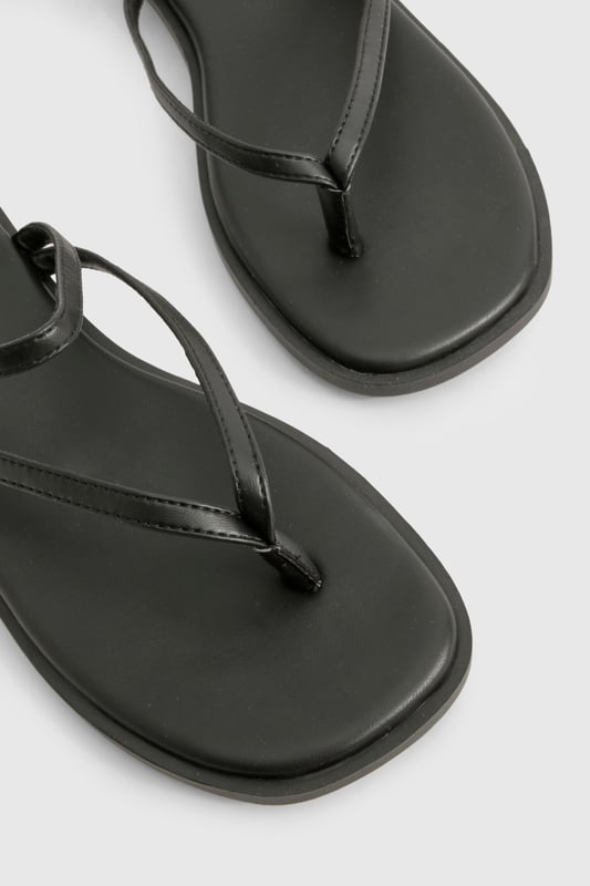 Sleek double strap design with elegant toe post detail
        Flat heel measuring between 0-2cm for all-day comfort
        Delicate gold-tone buckle fastening for adjustable fit
        Smooth PU construction with cushioned footbed
        Versatile slip-on style perfect for effortless summer dressing
    
    These minimalist double strap sandals are the ultimate warm-weather essential for the fashion-forward woman. The understated design features slender straps that delicately cross the foot, creating a flattering silhouette that works brilliantly with everything from floaty summer dresses to casual denim shorts. The practical flat sole ensures comfort for city exploring or beachside strolls, while the subtle gold-tone hardware adds just the right touch of sophistication. Style them with cropped trousers and an oversized linen shirt for daytime casual events, or pair with a flowing maxi dress for family gatherings and garden parties. These versatile sandals transition seamlessly from poolside to pavement, making them an indispensable addition to your holiday packing list and everyday summer wardrobe.