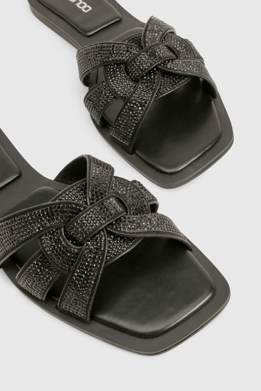 Stylish cut-out design with knotted straps
        Sparkling rhinestone embellishments for added glamour
        Flat heel (0-2cm) for all-day comfort
        Slip-on style for easy wear
        Versatile sandal suitable for various casual occasions
    
    These chic cut-out sandals are the perfect blend of style and comfort for the fashion-forward woman. The intricate knotted straps create an eye-catching design, while the sparkling rhinestones add a touch of glamour to elevate any casual ensemble. With their flat heel, these sandals are ideal for long days out and about, offering both comfort and style in equal measure. Pair them with your favourite summer dress for a family barbecue, or slip them on with cropped trousers for a leisurely weekend brunch with friends. The versatile design makes these sandals a go-to choice for various casual events, from shopping trips to seaside strolls. Their slip-on style ensures quick and easy wear, perfect for those on-the-go moments when you need to dash out the door in style.