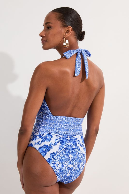 Make a splash in this eye-catching scarf print swimsuit from Karen Millen. The intricate pattern radiates sophistication, whilst the plunging neckline and high-cut leg create a sultry silhouette. Perfect for lounging by the pool or strolling along sun-drenched beaches, this swimsuit combines style with practicality. Pair with oversized sunglasses and a wide-brimmed hat for ultimate poolside glamour. For a stylish beach-to-bar look, throw on a sheer kaftan and wedge sandals. The halterneck tie allows for a customised fit, ensuring comfort throughout your sun-soaked adventures. Whether you're jetting off to a tropical paradise or enjoying a staycation, this swimsuit will have you feeling confident and fabulous.  Striking scarf print design for a luxurious look Plunging neckline adds a touch of allure Halterneck style with tie fastening for adjustable fit Figure-flattering cut with defined waistband High-cut leg elongates the silhouette