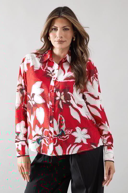 Bold floral print shirt with distinctive piping detail for a sophisticated edge
        Classic collared neckline with full button-through front closure
        Relaxed fit silhouette offering comfortable all-day wear
        Practical chest pocket adding both style and functionality
        Long sleeves with button cuffs for versatile styling options
    
    This striking Wallis shirt combines eye-catching floral patterns with elegant piping details for a piece that commands attention. The relaxed silhouette creates a flattering drape that works beautifully with the woven fabric, while the practical chest pocket adds a touch of casual charm. Style this versatile top with wide-leg trousers as shown for a sophisticated daytime look perfect for family gatherings or lunch with friends. For a more casual approach, pair with your favourite denim and trainers for weekend outings. The collared design can be worn fully buttoned for a polished appearance or with the top buttons undone for a more relaxed feel. This shirt transitions effortlessly from casual coffee dates to smart-casual office environments, making it an indispensable addition to your wardrobe.
