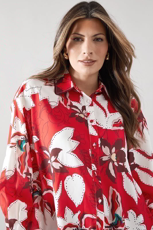 Bold floral print shirt with distinctive piping detail for a sophisticated edge
        Classic collared neckline with full button-through front closure
        Relaxed fit silhouette offering comfortable all-day wear
        Practical chest pocket adding both style and functionality
        Long sleeves with button cuffs for versatile styling options
    
    This striking Wallis shirt combines eye-catching floral patterns with elegant piping details for a piece that commands attention. The relaxed silhouette creates a flattering drape that works beautifully with the woven fabric, while the practical chest pocket adds a touch of casual charm. Style this versatile top with wide-leg trousers as shown for a sophisticated daytime look perfect for family gatherings or lunch with friends. For a more casual approach, pair with your favourite denim and trainers for weekend outings. The collared design can be worn fully buttoned for a polished appearance or with the top buttons undone for a more relaxed feel. This shirt transitions effortlessly from casual coffee dates to smart-casual office environments, making it an indispensable addition to your wardrobe.