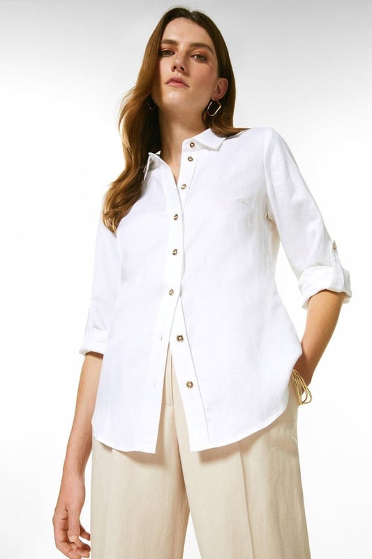 Timeless tailoring is presented with a proportional twist for this lightweight viscose linen shirt. This crisp piece has a point collar detailed with polished golden embossed buttons, and long sleeves. Pair this piece with tailored shorts and flats for a summer ensemble.Point collarButton detailingShirt