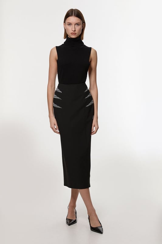 Experience updated wardrobe essentials with our midi skirt, with a straight silhouette and a high waistline, creating a universally flattering fit. The jacquard detailing adds immediate intrigue, elevating this piece beyond a basic. Style this piece with anything, from the matching jacket and strappy heels, to a knit jumper, tights, and boots. Compact Stretch Jacquard Insert Midi Pencil Skirt Sleek, Minimal Design Comfortable High Waistline Flattering Straight Silhouette Unique Insert Details on Hips Zip Back Fastening Matching Jacket Sold Separately