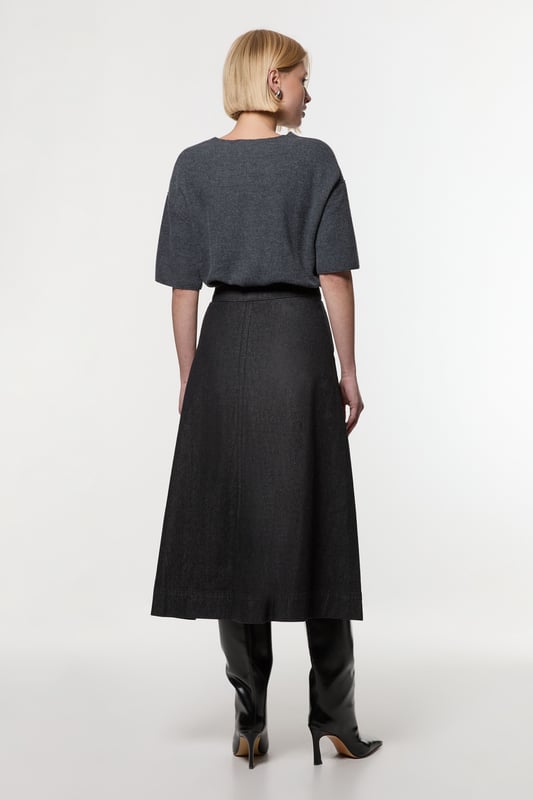 This Karen Millen denim midi skirt is a versatile wardrobe staple that effortlessly bridges the gap between casual and smart-casual attire. The full, flared silhouette creates a graceful movement as you walk, while the high-waisted design accentuates your natural curves. Style it with a fitted knit top and ankle boots for a stylish daytime look, perfect for weekend brunches or casual family gatherings. For a more relaxed vibe, pair it with a simple t-shirt and trainers. The side pockets add a practical touch, ideal for keeping small essentials close at hand. This skirt's adaptable nature makes it suitable for various occasions, from laid-back office days to informal evening outings. Its timeless design ensures it will remain a go-to piece in your wardrobe for seasons to come.  Midi-length denim skirt with a full, flared silhouette High-waisted design for a flattering fit Side pockets for practicality and style Versatile cotton fabric suitable for various seasons Subtle A-line shape creates a feminine profile