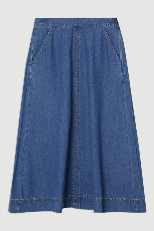 This Karen Millen denim midi skirt is a versatile wardrobe staple that effortlessly bridges the gap between casual and smart-casual attire. The full, flared silhouette creates a graceful movement as you walk, while the high-waisted design accentuates your natural curves. Style it with a fitted knit top and ankle boots for a stylish daytime look, perfect for weekend brunches or casual family gatherings. For a more relaxed vibe, pair it with a simple t-shirt and trainers. The side pockets add a practical touch, ideal for keeping small essentials close at hand. This skirt's adaptable nature makes it suitable for various occasions, from laid-back office days to informal evening outings. Its timeless design ensures it will remain a go-to piece in your wardrobe for seasons to come.  Midi-length denim skirt with a full, flared silhouette High-waisted design for a flattering fit Side pockets for practicality and style Versatile cotton fabric suitable for various seasons Subtle A-line shape creates a feminine profile