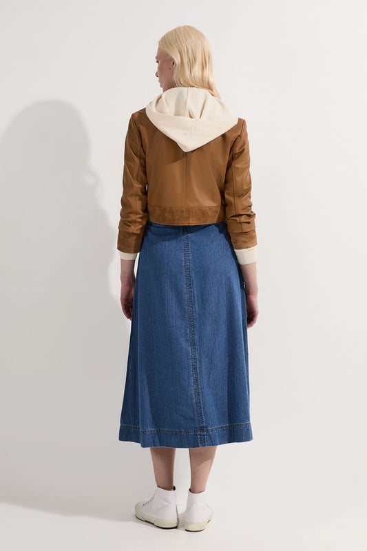 This Karen Millen denim midi skirt is a versatile wardrobe staple that effortlessly bridges the gap between casual and smart-casual attire. The full, flared silhouette creates a graceful movement as you walk, while the high-waisted design accentuates your natural curves. Style it with a fitted knit top and ankle boots for a stylish daytime look, perfect for weekend brunches or casual family gatherings. For a more relaxed vibe, pair it with a simple t-shirt and trainers. The side pockets add a practical touch, ideal for keeping small essentials close at hand. This skirt's adaptable nature makes it suitable for various occasions, from laid-back office days to informal evening outings. Its timeless design ensures it will remain a go-to piece in your wardrobe for seasons to come.  Midi-length denim skirt with a full, flared silhouette High-waisted design for a flattering fit Side pockets for practicality and style Versatile cotton fabric suitable for various seasons Subtle A-line shape creates a feminine profile